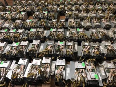A large mining farm with rows of mining rigs